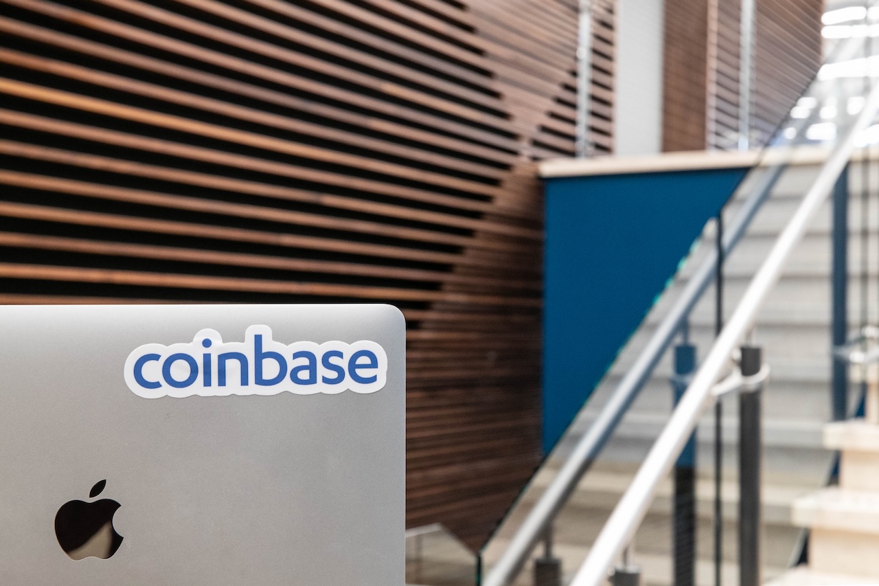 A laptop with a sticker of the Coinbase logo. Coinbase's layer 2 Base is reportedly considering a token.