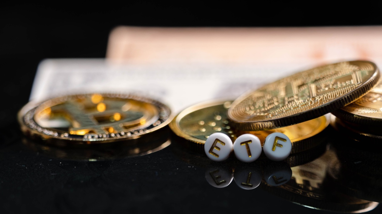 An image of several physical coins representing Bitcoin and letters spelling ETF.